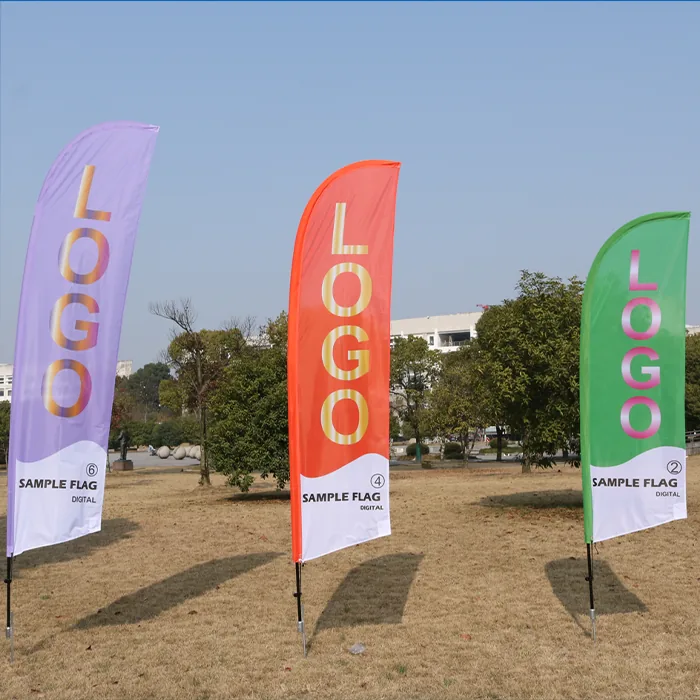 Custom feather flags in purple, orange and green printed with LOGO on a lawn