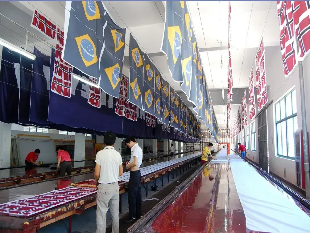 Rows of freshly printed custom flags hanging to dry in the Wolflag workshop